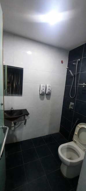 A bathroom with a white sink, a toilet, and a shower. - OYO 90724 Rg Hotel (Ayer Hitam)
