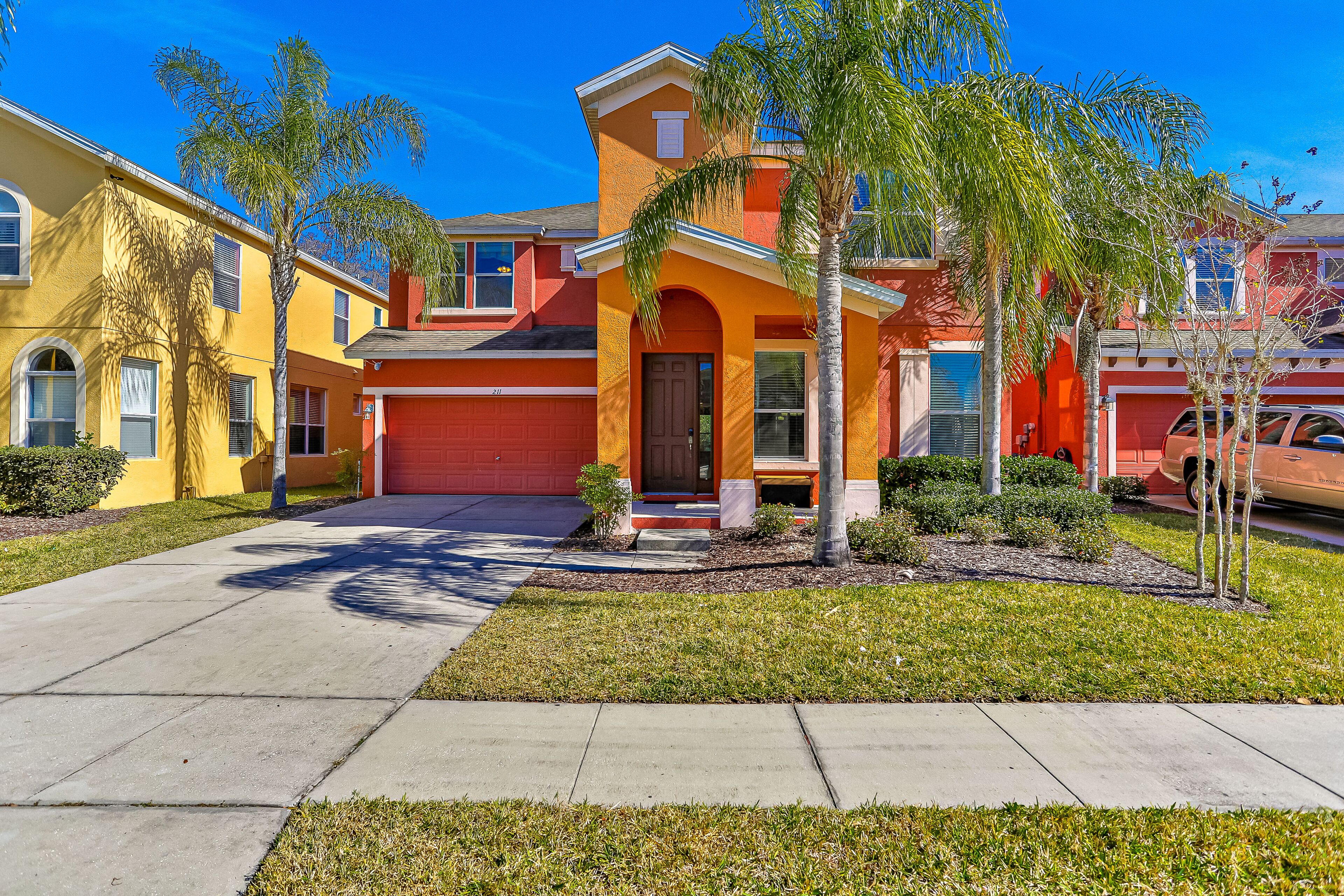 Colorful home with pool, gas grill, patio, kitchen, washer/dryer, & game room