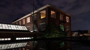 A multi-story building with large windows and a staircase. - Hotel Piet Hein Eek (Eindhoven)