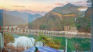 A suspension bridge over a river with a mountainous backdrop. - BS Jecheon Pension (Jecheon)
