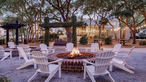 An outdoor seating area with Adirondack chairs arranged around a central fire pit. - Marriott's SurfWatch - Upscale Resort On The Beach! (Hilton Head Island)