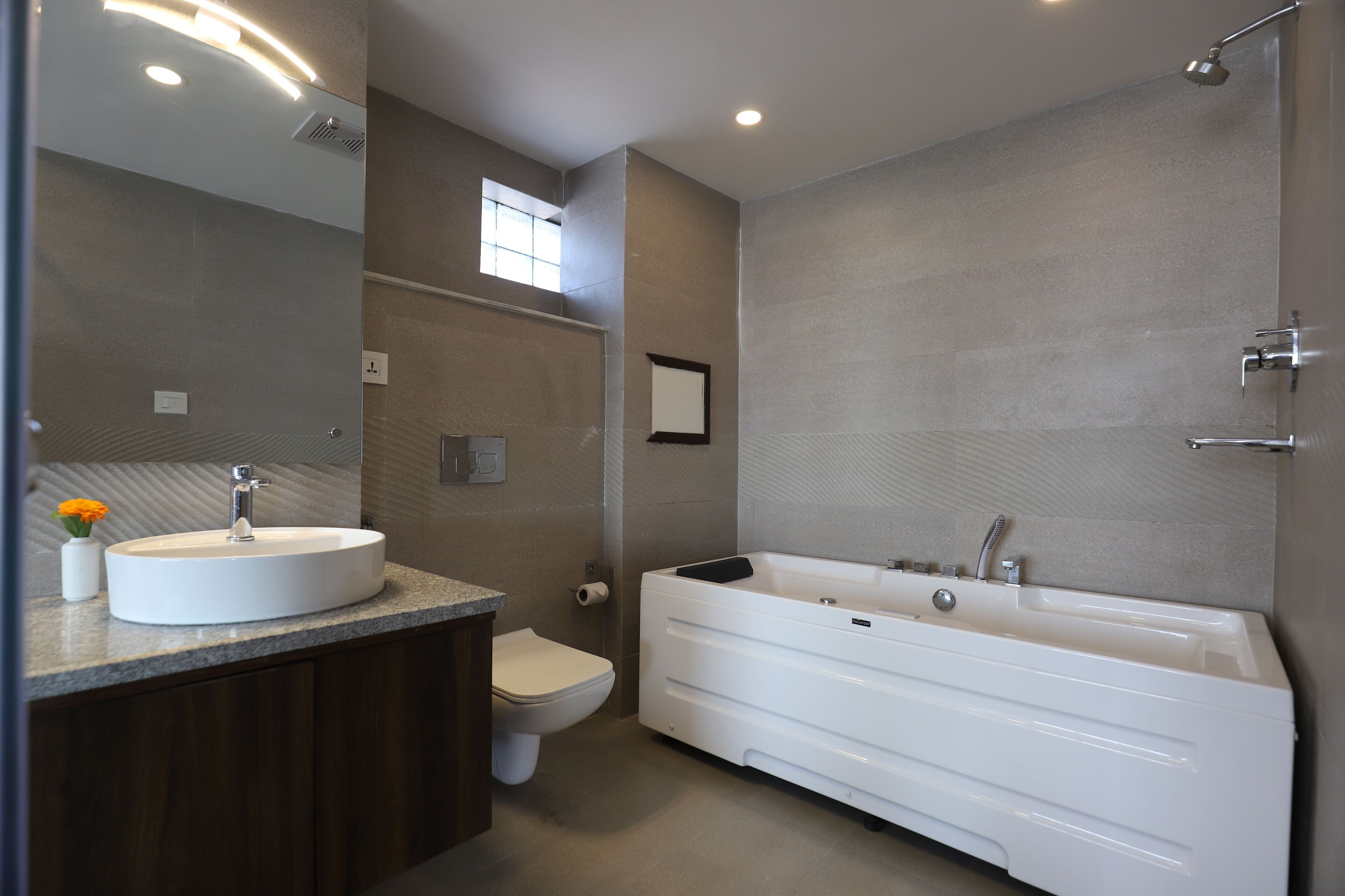 business studio suite | bathroom | deep-soaking bathtub, rainfall showerhead, hair dryer, slippers