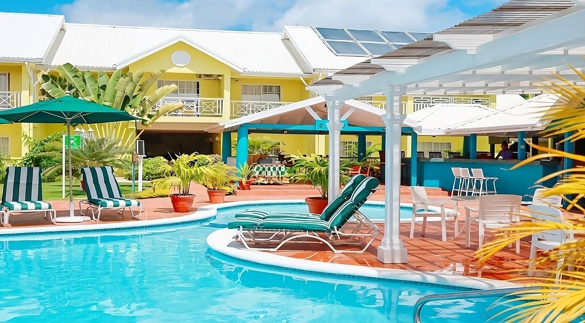 Lounge poolside on spacious decks under warm island sunshine.