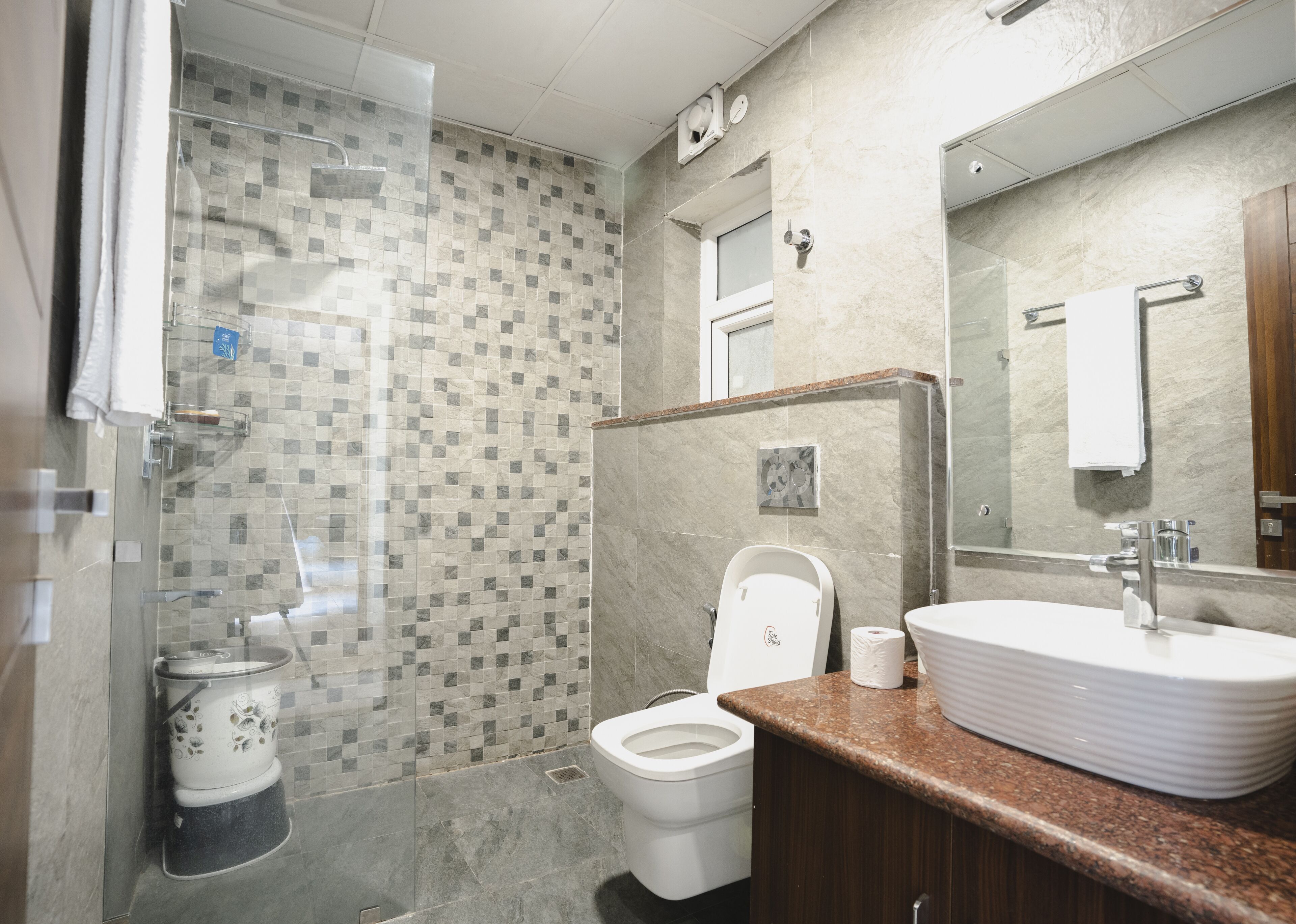 A bathroom with a shower, toilet, and sink.