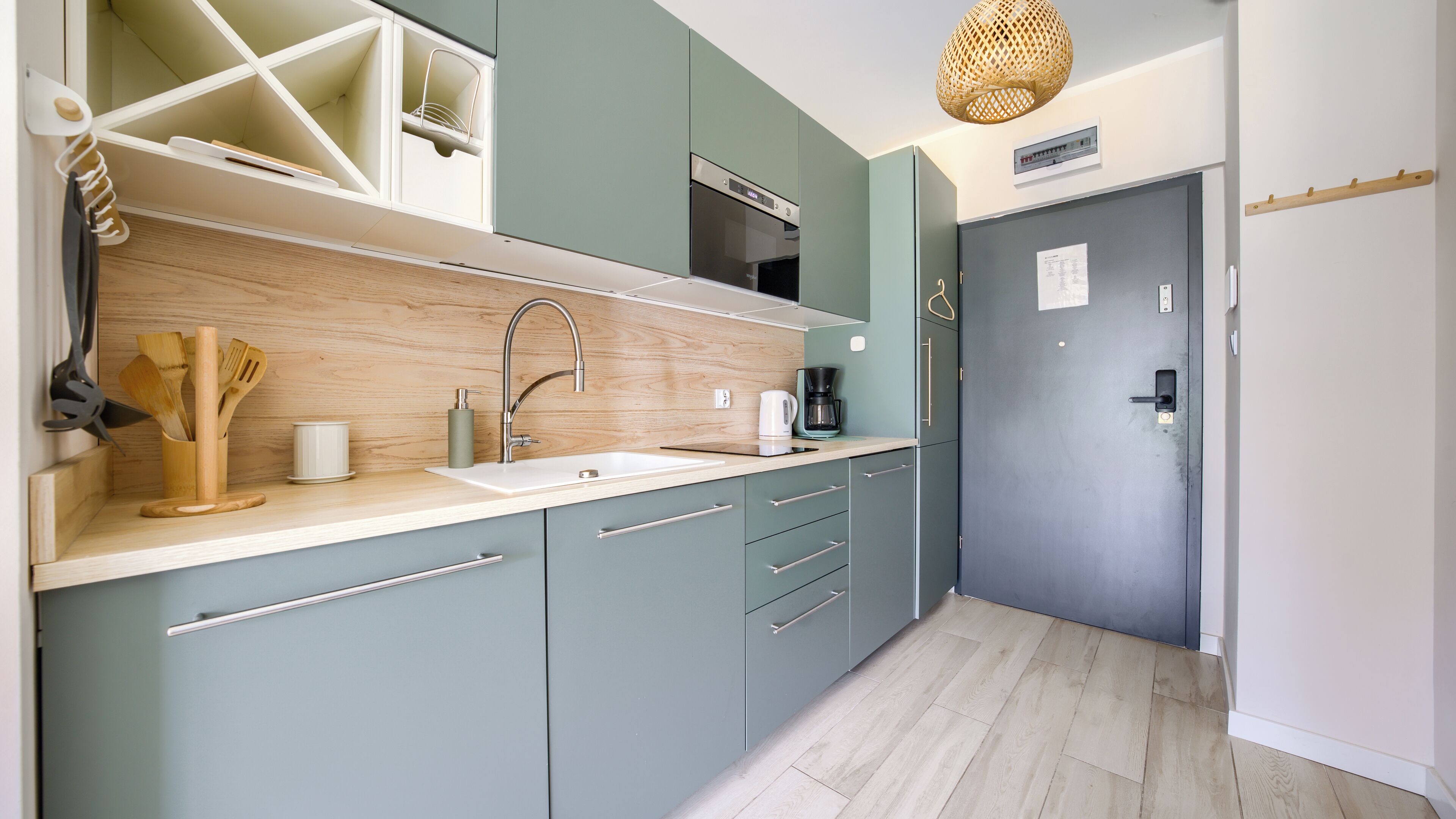 A modern kitchen with a sink, stove, and cabinets.