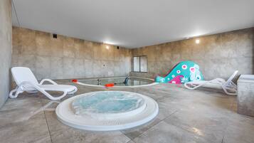 Relax by the central hot tub surrounded by comfortable lounge chairs.