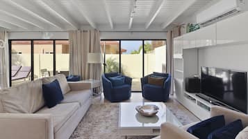 Luxury Condo, 2 Bedrooms, Patio, Ground Floor | Living area | 50-inch Smart TV with digital channels, TV, streaming services