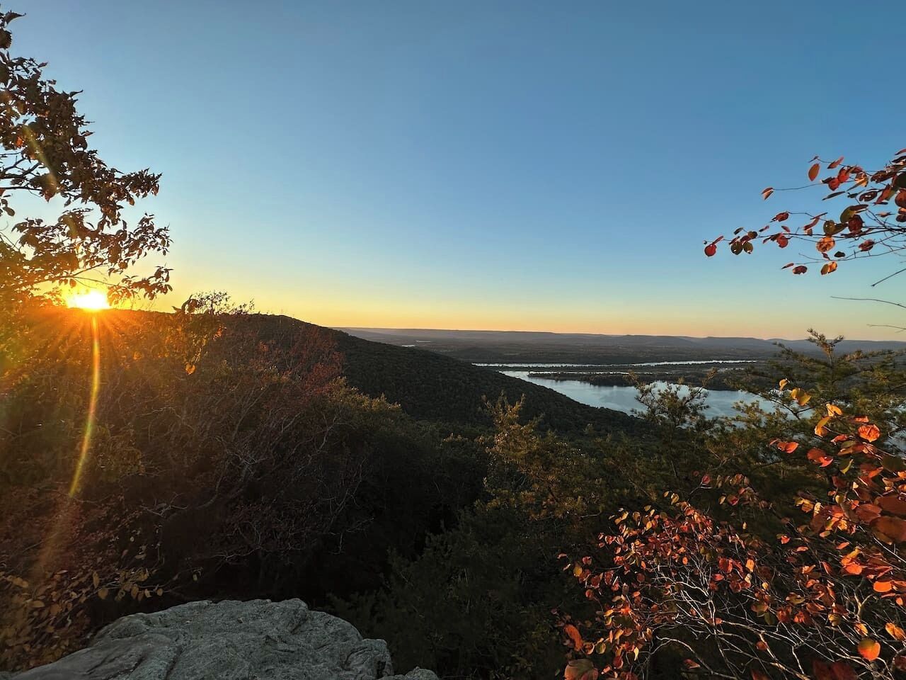 A mountainous landscape with a lake and a clear sky.