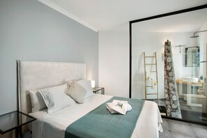 A hotel room with a bed, a nightstand, a glass shower enclosure, and a bathroom visible through the glass door. - Holiday Apartment "Carmelo Y Carmela 3" with Mountain View, Private Terrace & Wi-Fi (teror)