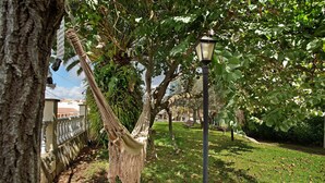 A hammock hanging from a tree, a lamp post, and a stone wall. - Holiday Apartment "Carmelo Y Carmela 6" with Mountain View, Private Terrace & Wi-Fi (Teror)