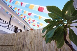Pared de bambu com uma planta em primeiro plano.