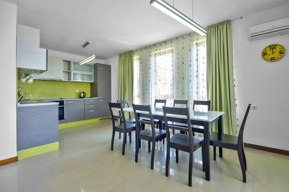 A modern kitchen with a dining area.