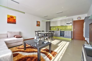 Standard Apartment | Living area | 32-inch LCD TV with cable channels, TV
