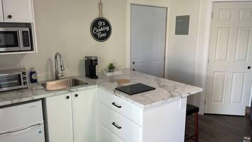 Fridge, stovetop, coffee/tea maker, cookware/dishes/utensils