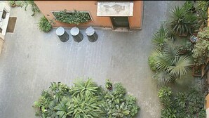 An aerial view of a courtyard with potted plants, a seating area with tables and chairs, and a building with a window and door. - Loft in The heart of Ancient Rome (Roma)