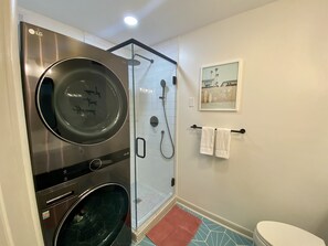 Shower, hair dryer, towels, shampoo