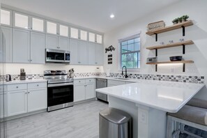Coffee/tea maker, fridge, microwave, oven