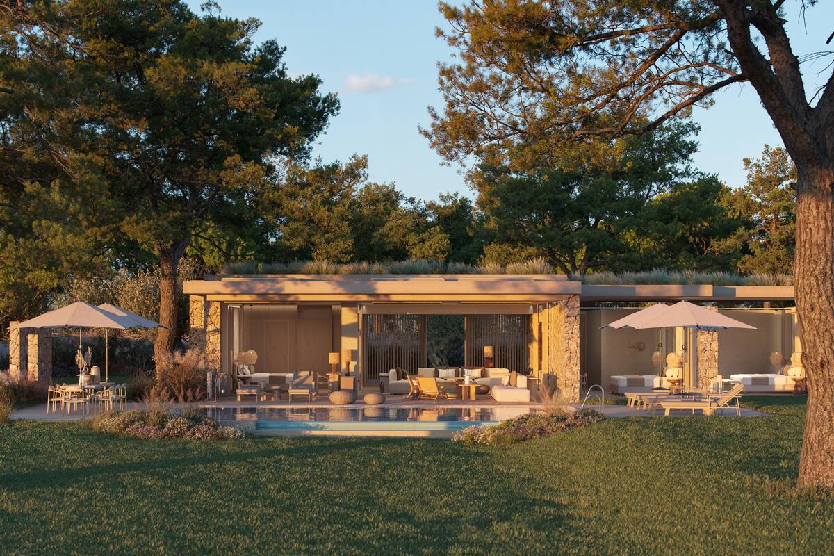 A modern house with a pool, outdoor seating, and a stone facade.