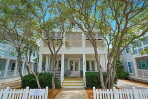 A two-story house with a porch, a front door, and a number '30' sign.
