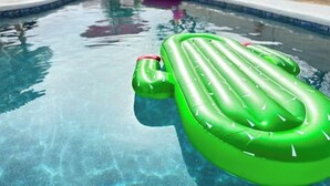 A swimming pool with inflatable green lounge chairs. - The Hugging Cactus. Old Town's Finest.  (Scottsdale)