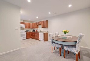 Enjoy cooking in this well-equipped kitchen with a central island, sink, and dining table.