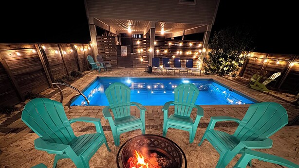 A backyard with a swimming pool, outdoor seating, and a fire pit. - FREE POOL HEAT thru 2026! Golf Cart, Private Pool, Dogs OK (St. George Island)
