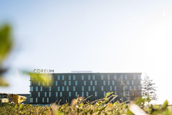 A modern building with the name "COREUM" on the top.
