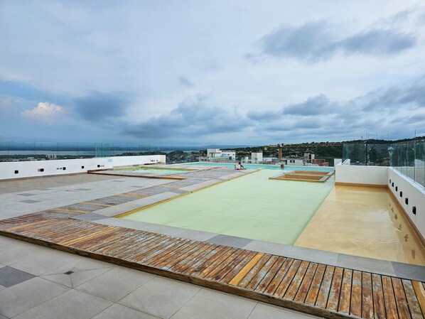 A rooftop pool with a view of the cityscape.