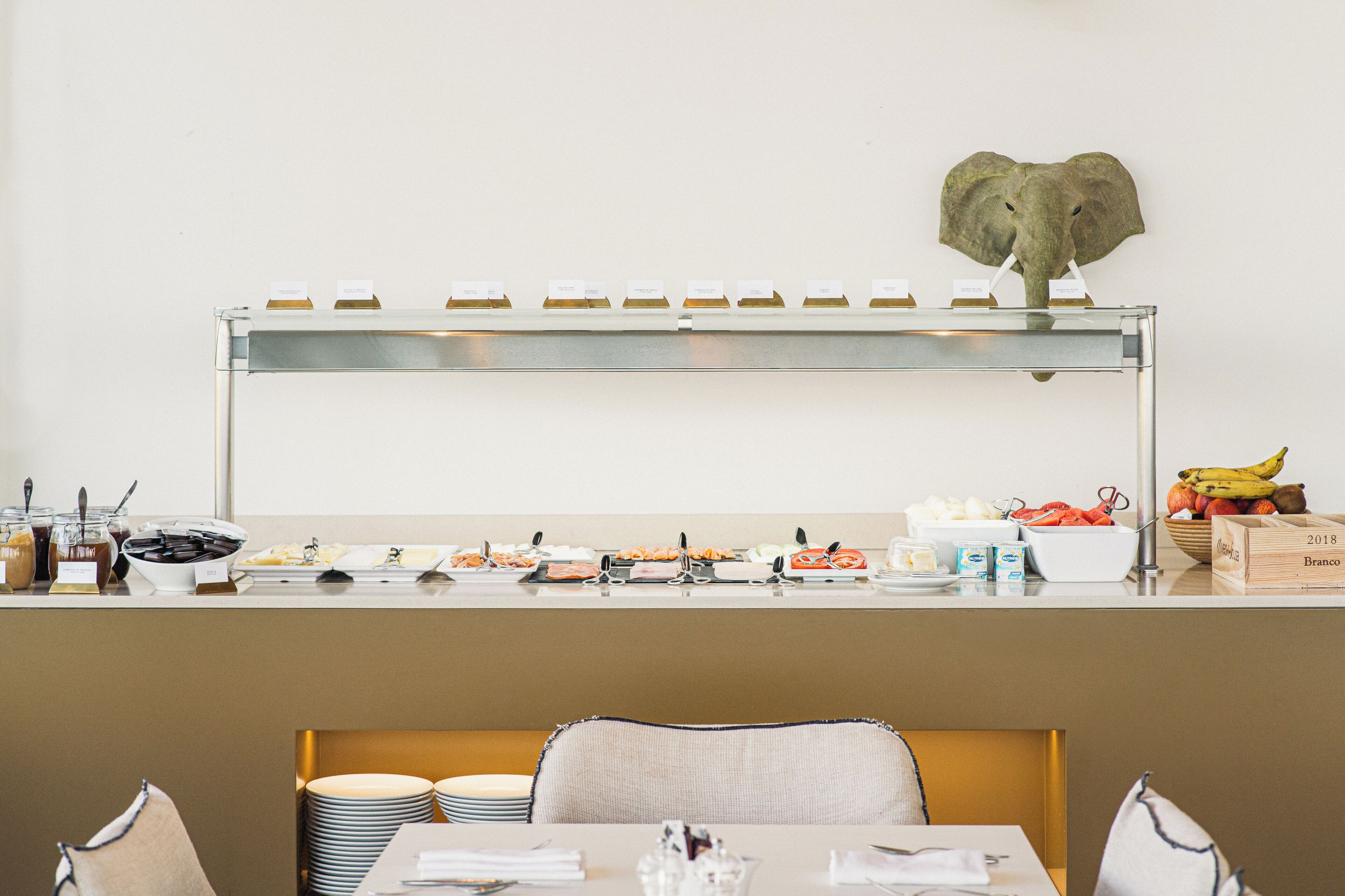 A buffet setup with various food items and utensils.