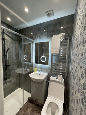 Shower, hair dryer, towels, soap