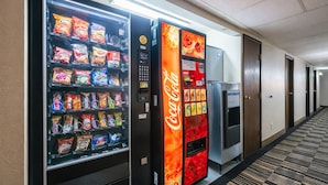 A hotel hallway with vending machines offering snacks and Coca-Cola. - Hotel 8 (Fergus Falls)