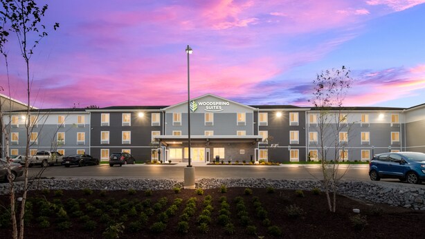 A hotel with a modern design, featuring a central entrance and multiple windows. - Woodspring Suites Hermitage - Nashville Airport (Hermitage)