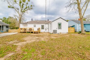 A residential house with a front yard, a wooden deck, and a garage. - Modern Home, Great Deck & Yard- Peaceful at Potter (Mobile)