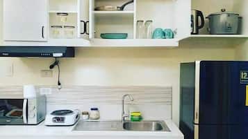Deluxe Condo | Private kitchen | Full-sized fridge, microwave, stovetop, coffee/tea maker