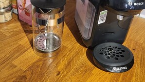 A kitchen counter with a coffee maker, a glass container, and a candy shop box. - Charming chalet-style accommodation, 12 minutes from the town center (Schiltigheim)