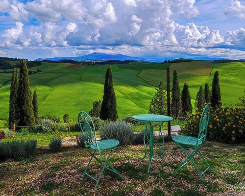 Mascagni farmhouse among the olive trees and the Tuscan hills in the Val d'Orcia