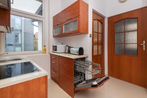 Apartment, 3 Bedrooms, Kitchen, Beachside | Private kitchen | Microwave, dishwasher, cookware/dishes/utensils, dining tables
