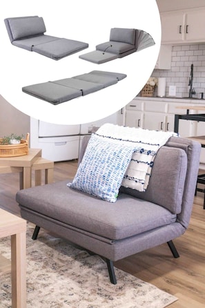 A grey sofa with a patterned throw pillow in a modern kitchen setting. - Casita Moderna | Near SWOSU, Downtown, & I-40! (Weatherford)