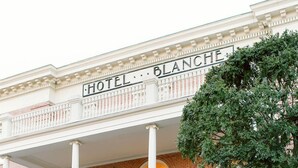 A hotel with a classic facade, featuring a prominent sign reading "HOTEL BLANCHE". - The Blanche  (Lake City)