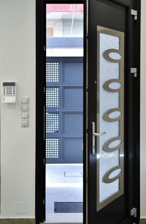 A door with a frosted glass panel and a keypad lock. - Modern Villa in Heraklion City Center, Crete (Heraklion)
