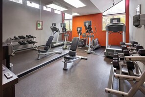 A gym with treadmills, elliptical machines, and dumbbells. - Tysons Corner Suites, A Baymont by Wyndham (Vienna)