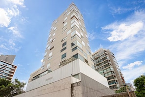 A high-rise building with multiple floors, large windows, and a modern architectural design.