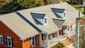 A two-story house with a sloped roof, a front porch, and a visible front yard. - The Berg Life:  Relax, Fish & Explore the Crystal Co (Marshallberg)