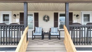 A porch with two chairs, a wooden staircase, and a number 39 sign. - Hampton Beach ♡ Ocean Retreat - Steps From The Sand and Strip! (Hampton)