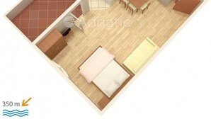 Un appartement comprenant deux chambres, une cuisine, une salle de bain et un balcon.