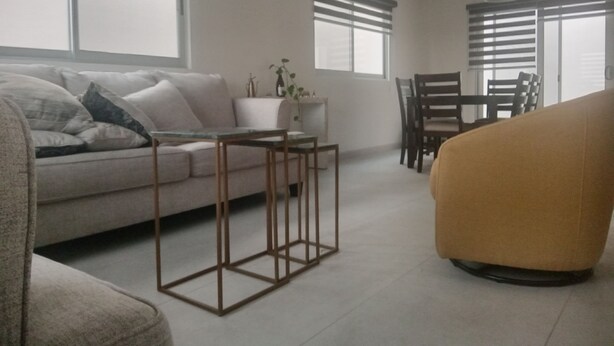 A modern living room with a sofa, a coffee table, and a dining area with chairs. - Casa Coral 25, private, safe and in a privileged location... (Ensenada)
