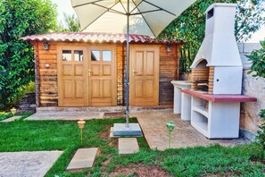Enjoy outdoor cooking at this cabin with a barbecue grill and well-manicured lawn.