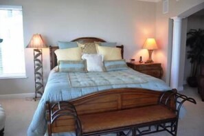A bedroom with a bed, two bedside tables, and lamps. - Gorgeous 4 Bdr beachfront condo in gated community (Marco Island)