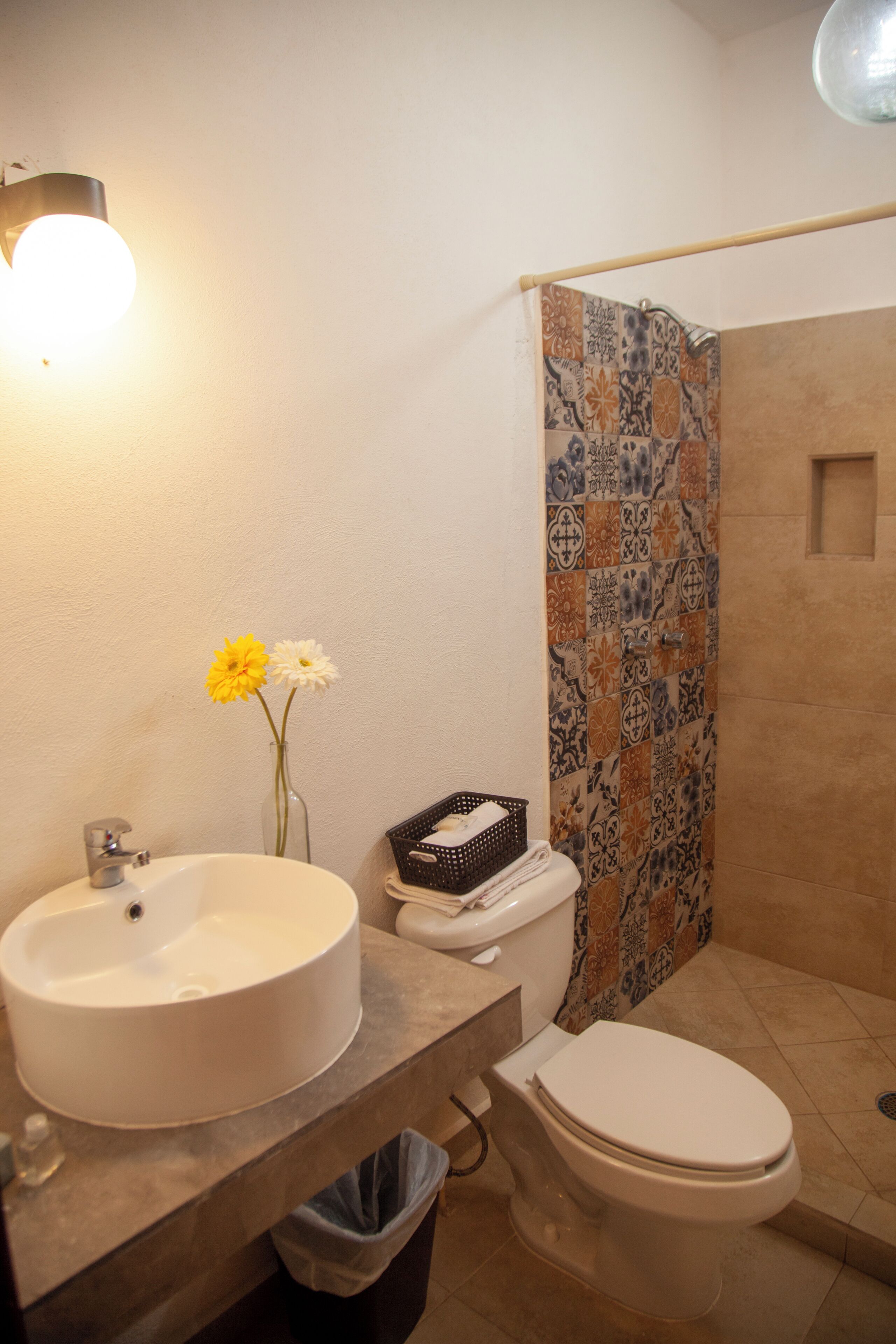 A bathroom with a sink, toilet, and shower.