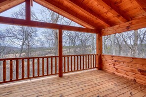 A wooden deck with a railing, large windows, and a view of trees and mountains. - Bluebonnet Luxury Cabin - in the Hocking Hills (Logan)